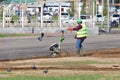 Work guest worker plows the lawn with a motor-plow.